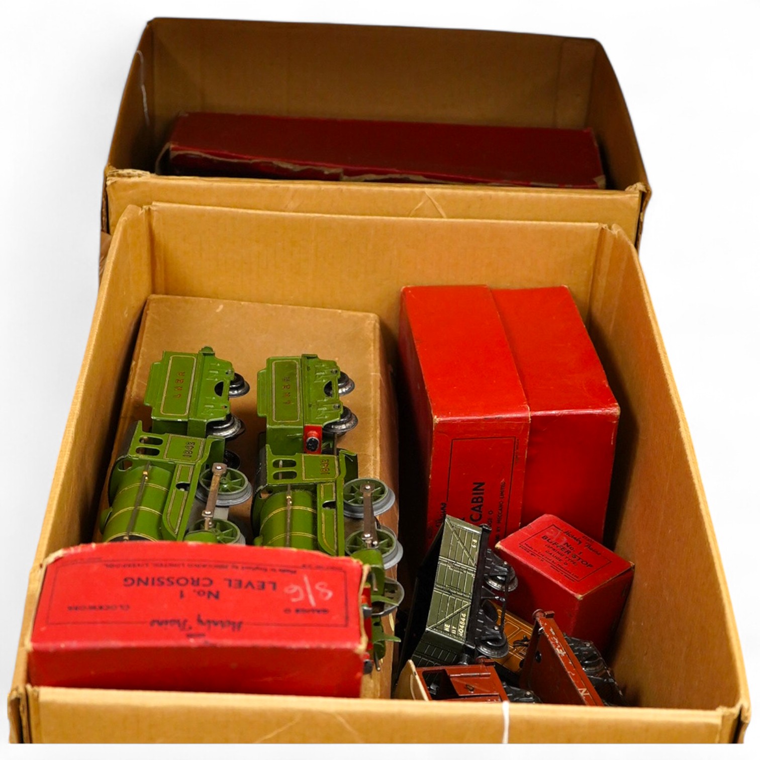 A collection of Hornby clockwork tinplate 0 gauge railway, including; two LNER 0-4-0 tender locomotives, both 1842, (No.501), together with six 4-wheel wagons and coaches, a boxed No.3 Station, level crossing, signal cab